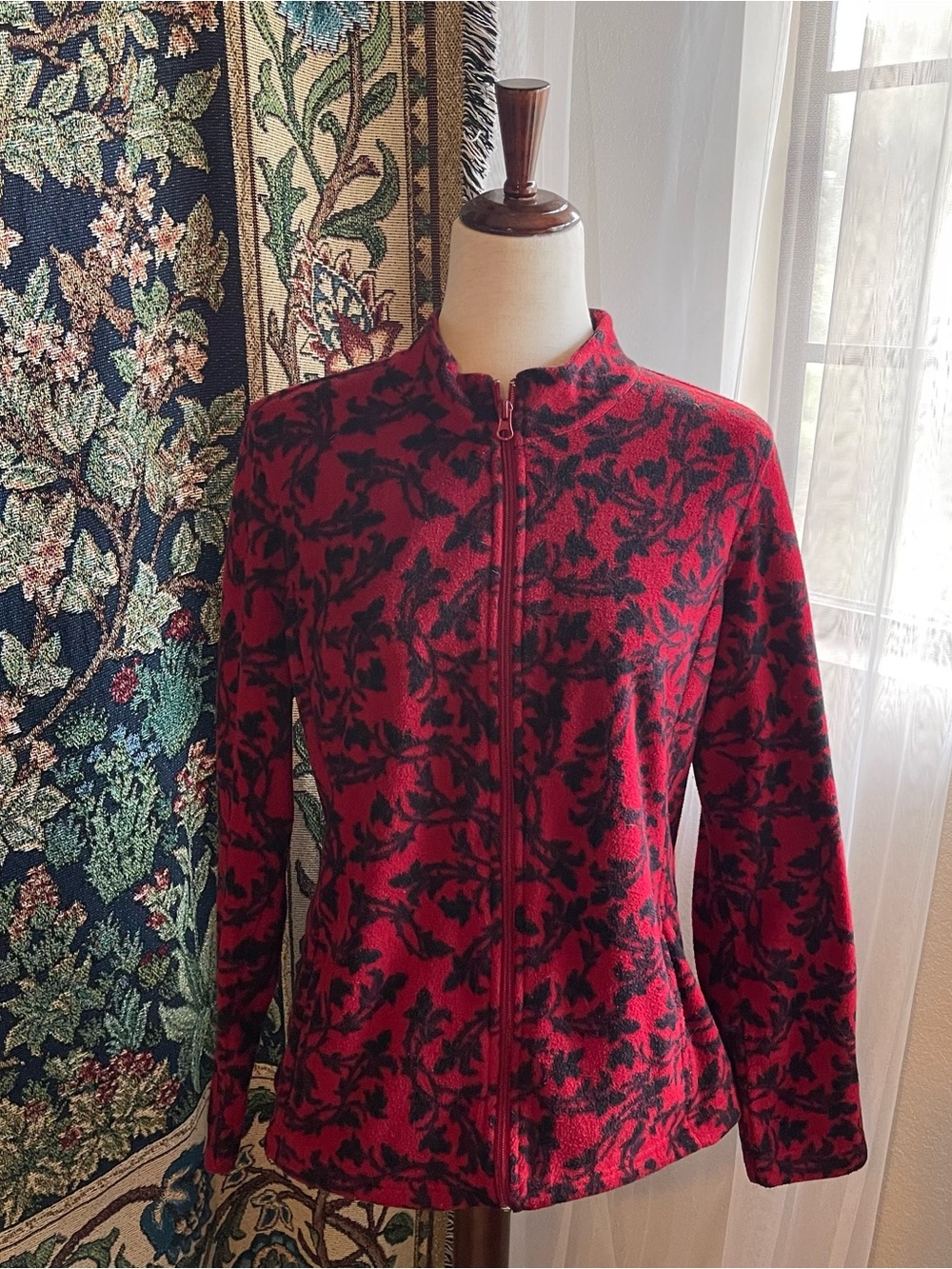 Red and black ornate print zip-up fleece jacket with high collar. Long sleeves